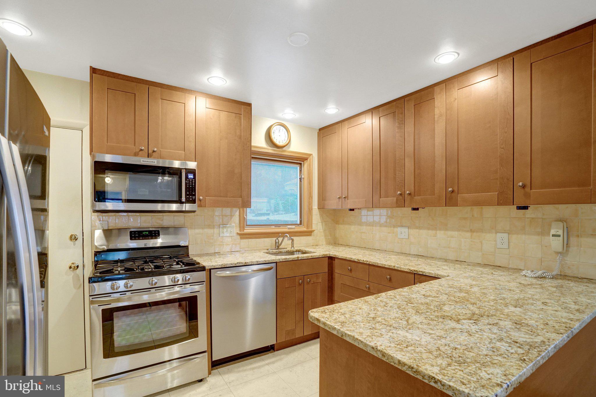 5417 Juliet Street Springfield, VA 22151 - Photo 11 of 46 a kitchen with a sink a stove and a microwave