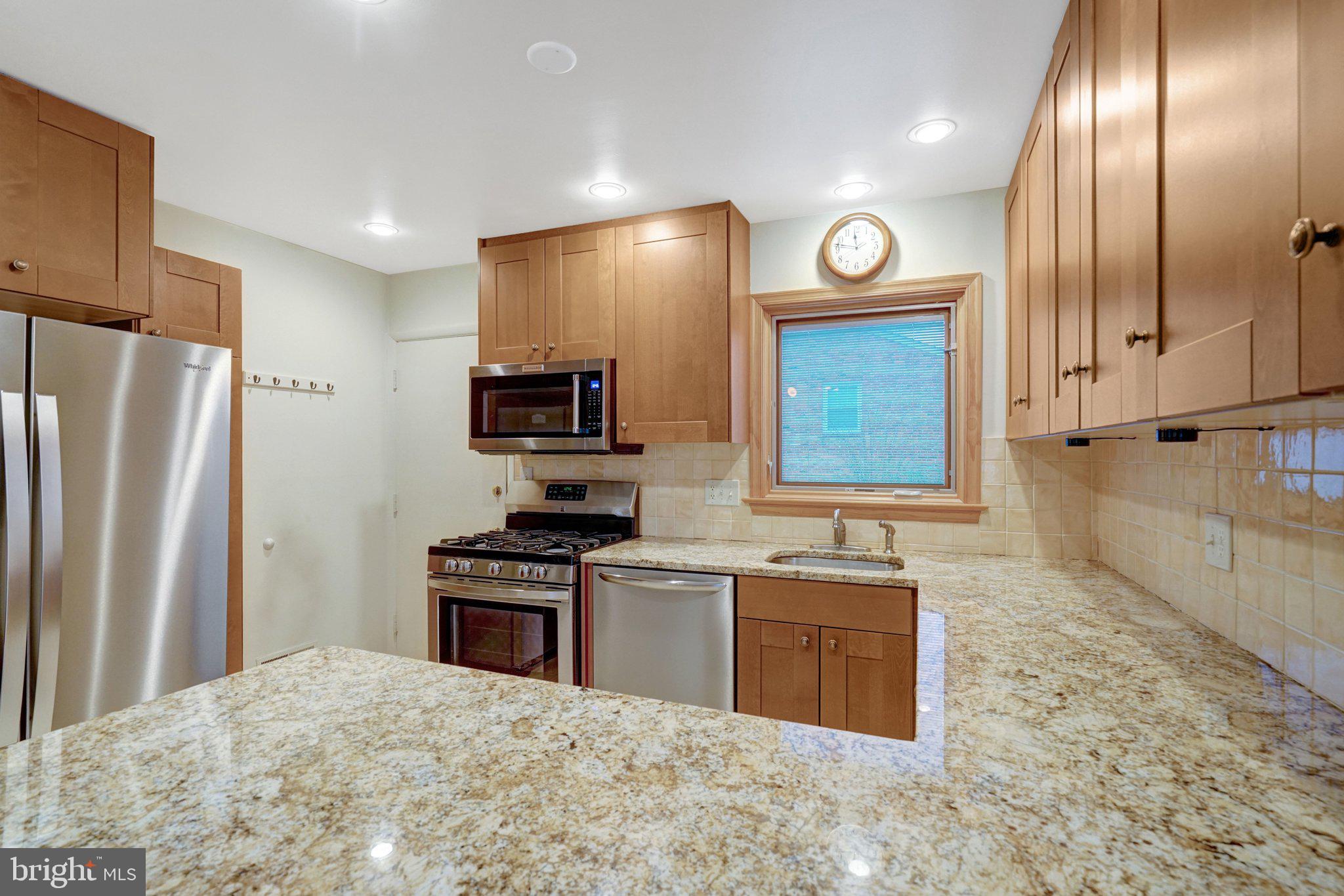 5417 Juliet Street Springfield, VA 22151 - Photo 12 of 46 a kitchen with stainless steel appliances granite countertop a stove a sink and a refrigerator