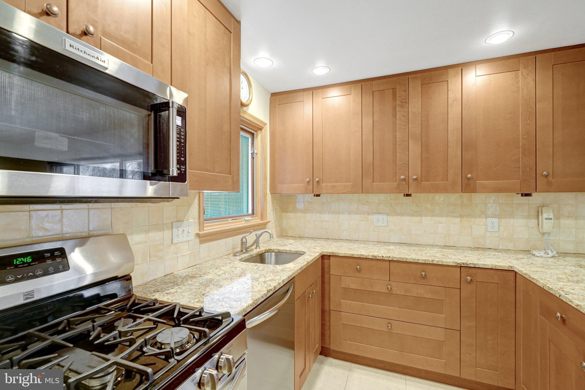 5417 Juliet Street Springfield, VA 22151 - Photo 13 of 46 a kitchen with granite countertop a stove and a sink