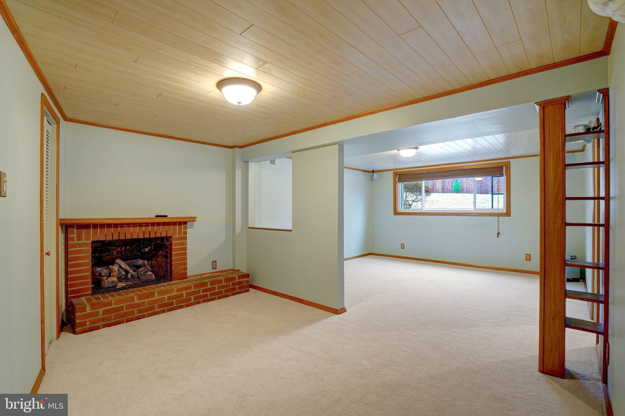 5417 Juliet Street Springfield, VA 22151 - Photo 27 of 46 a view of an empty room with a fireplace and a window