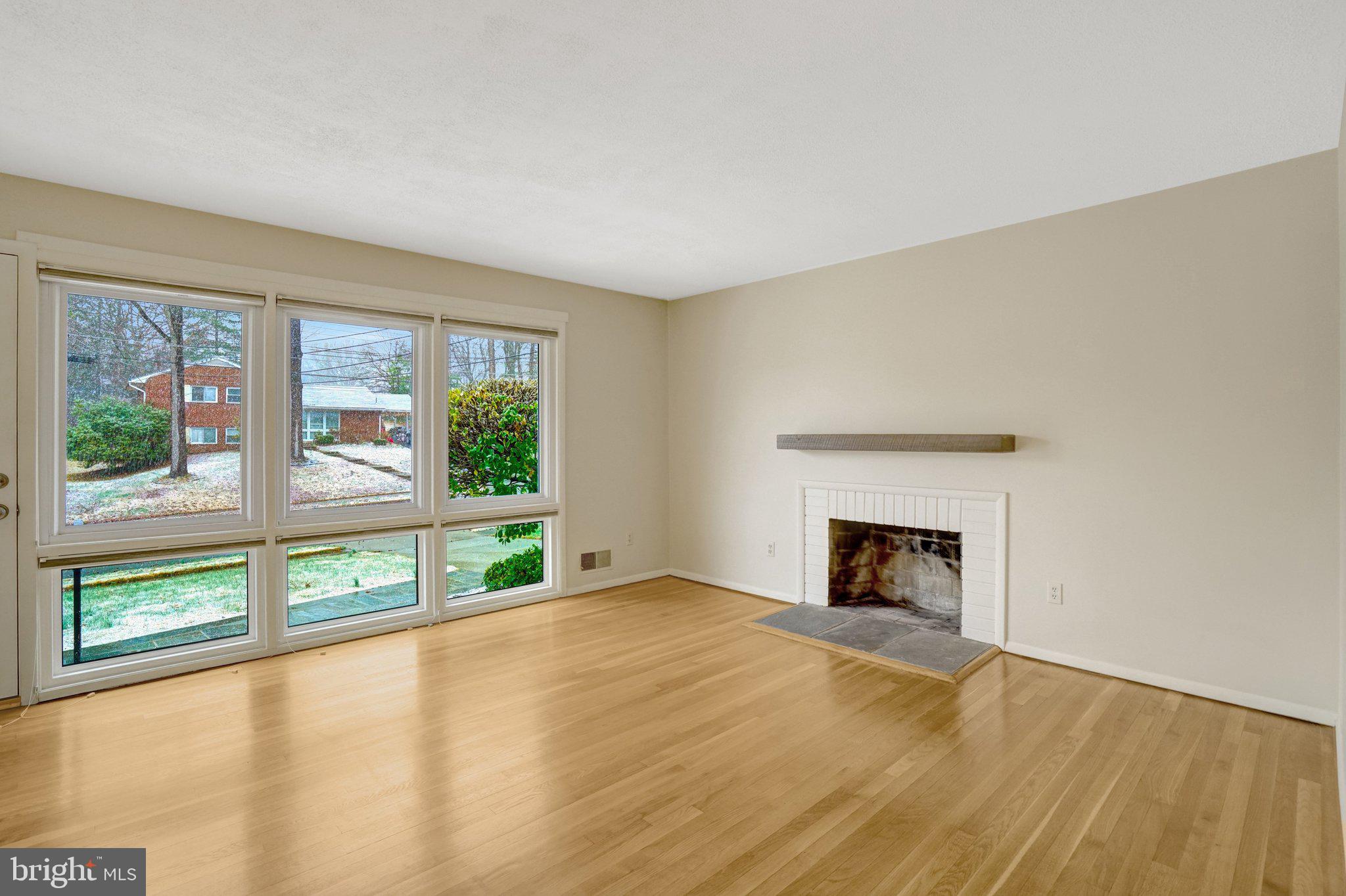 5417 Juliet Street Springfield, VA 22151 - Photo 6 of 46 wooden floor fireplace and windows in an empty room