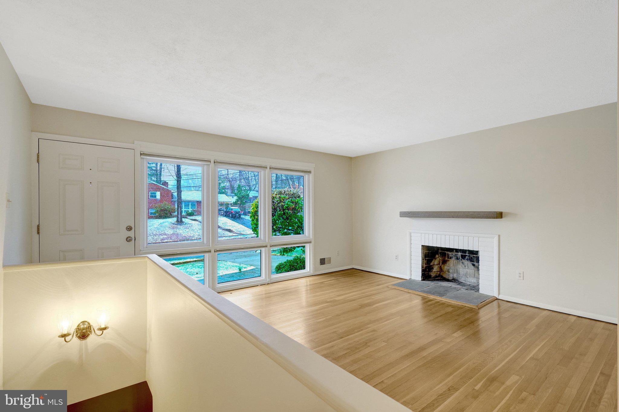 5417 Juliet Street Springfield, VA 22151 - Photo 7 of 46 a view of an empty room with a fireplace and a window