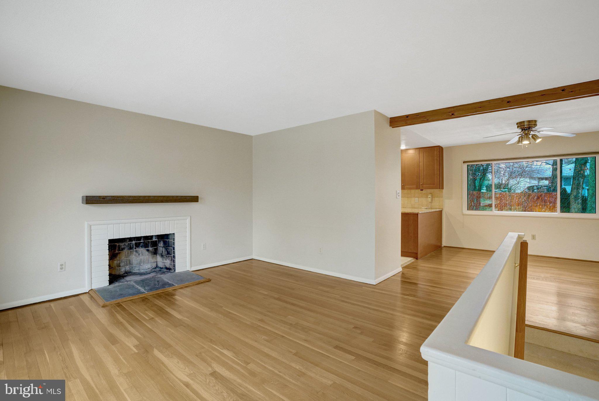 5417 Juliet Street Springfield, VA 22151 - Photo 8 of 46 a view of empty room with wooden floor and fireplace