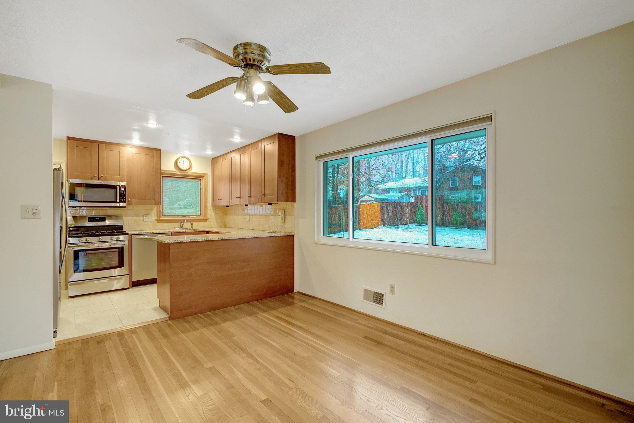 5417 Juliet Street Springfield, VA 22151 - Photo 9 of 46 a large kitchen with stainless steel appliances wooden floor and a large window