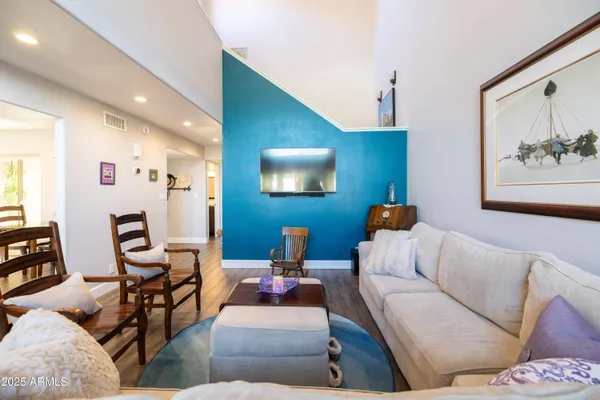 a living room with furniture and a wooden floor