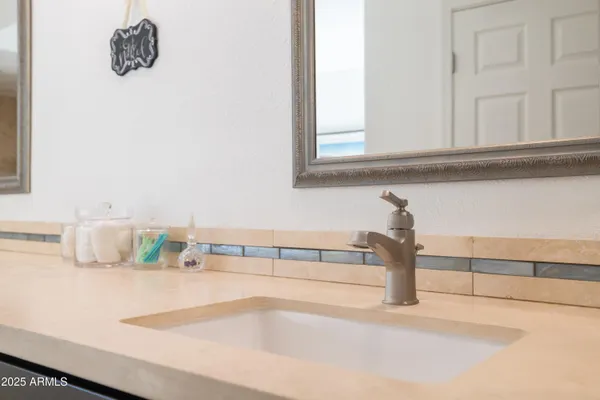 a view of a tree in a backyard of a house