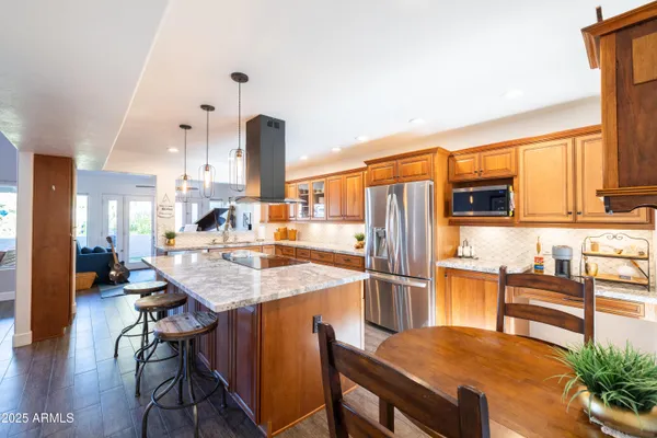 a kitchen with granite countertop a sink and cabinets