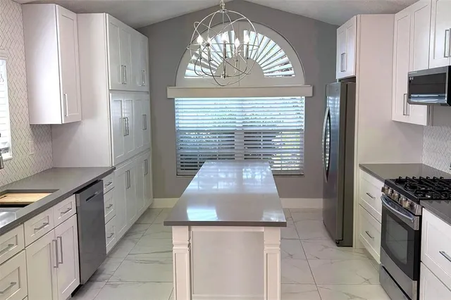 a kitchen with a stove and a white cabinet