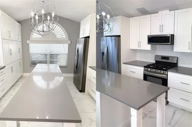 a kitchen with stainless steel appliances a stove a refrigerator a kitchen island a stove and a cabinets