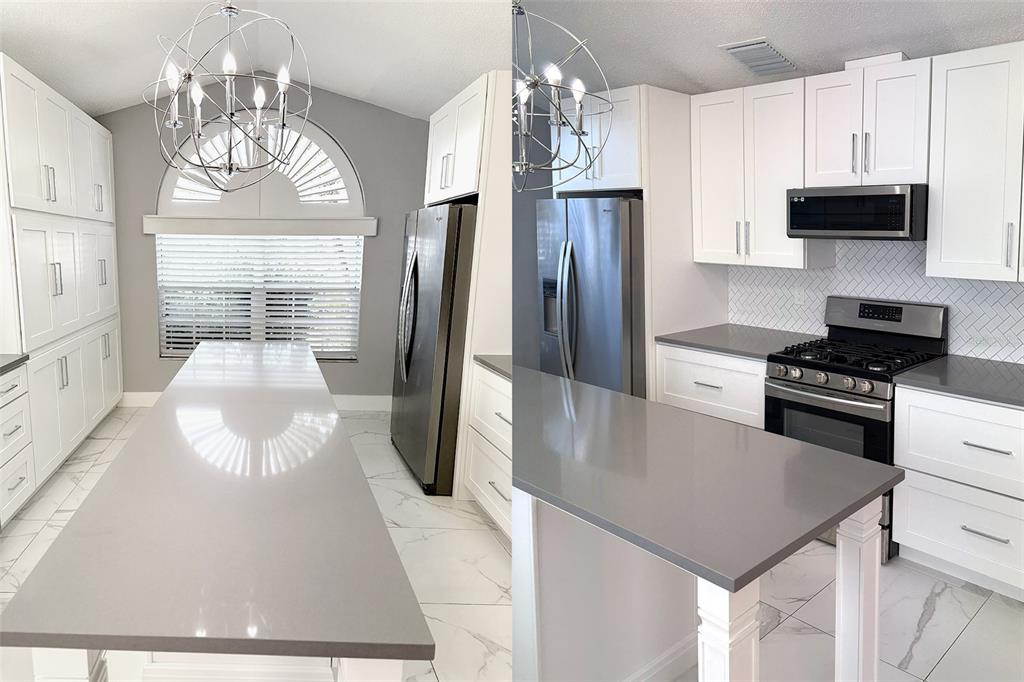 8520 Heyward Road Tampa, FL 33635 - Photo 5 of 12 a kitchen with stainless steel appliances a stove a refrigerator a kitchen island a stove and a cabinets