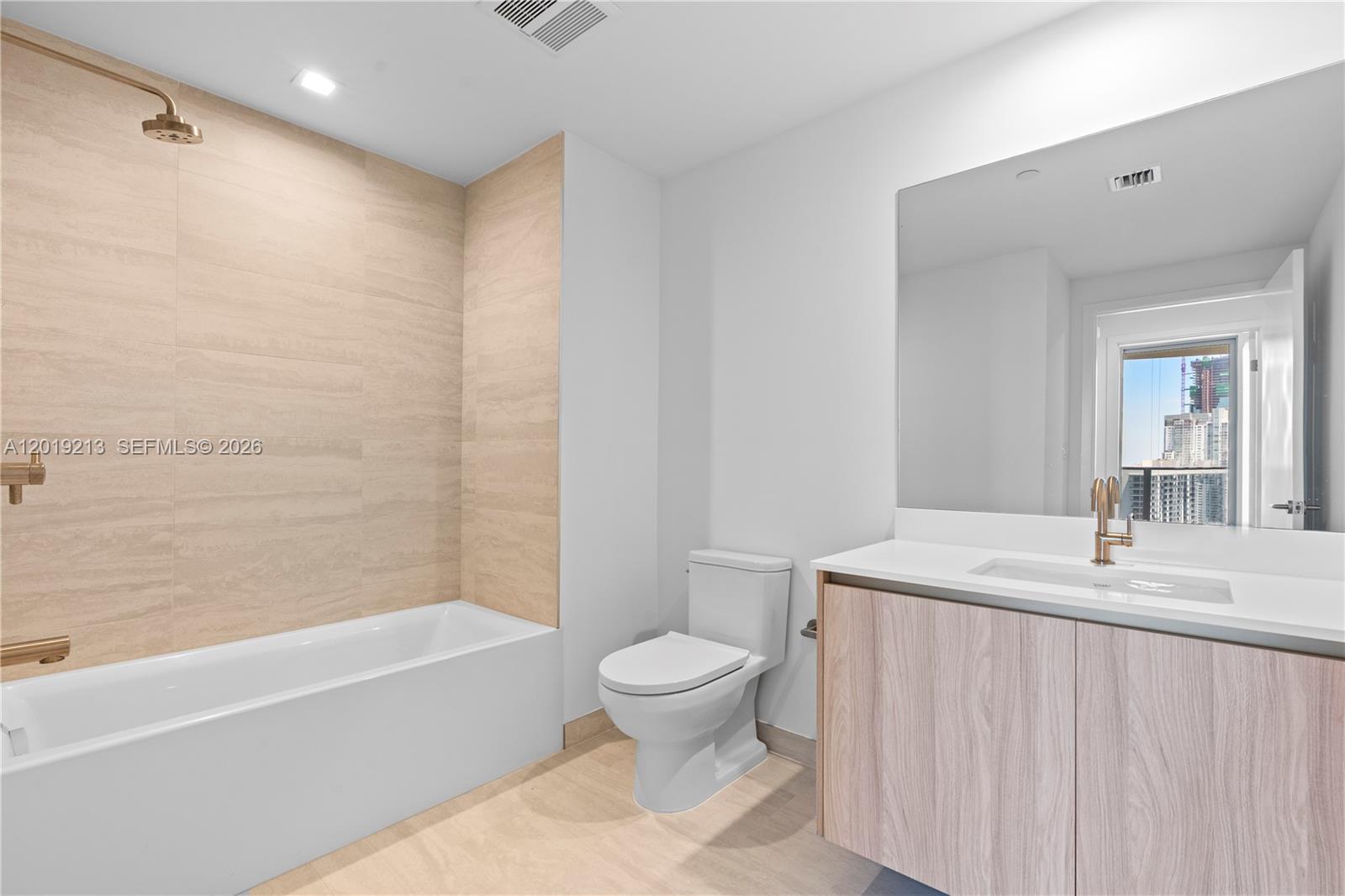 77 Southeast 5th, Unit 3702 Miami, FL 33131 - Photo 34 of 63 a bathroom with a sink a toilet and a bathtub