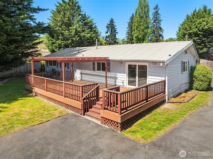 a view of a house with a yard wooden floor and a fence