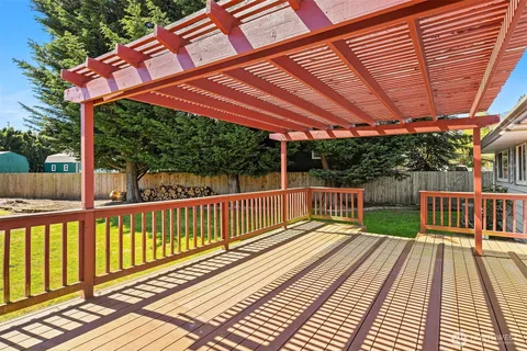 a view of a wooden deck with a yard