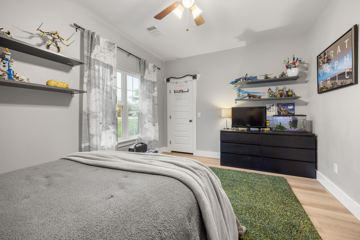 8 Butterfly Street Wimberley, TX 78676 - Photo 15 of 27 Bedroom with light wood-style flooring and a ceiling fan
