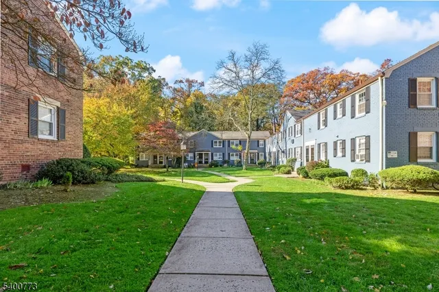 a view of a brick house with a yard