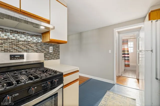 a stove top oven sitting inside of a kitchen