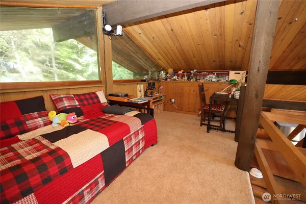 a bed room with a bed and a chair