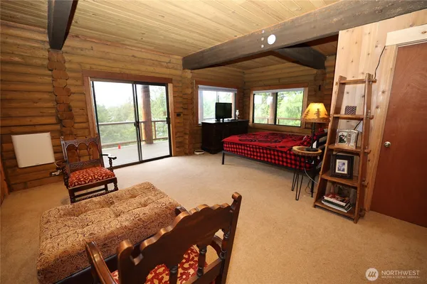 a bedroom with furniture and wooden floor