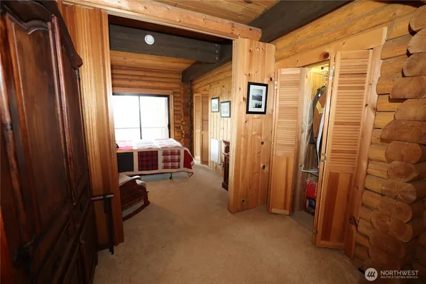 a view of a hallway with furniture and a window