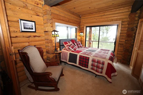 a bed room with a bed chair and a window