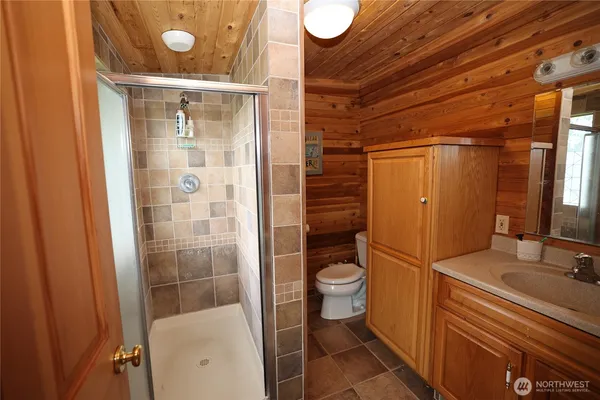 a bathroom with a toilet and a shower