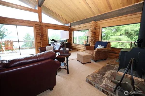 a living room with furniture and a floor to ceiling window