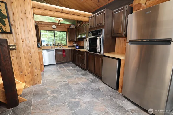 a kitchen with stainless steel appliances a refrigerator and a cabinets