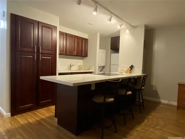 a kitchen with a sink refrigerator and cabinets