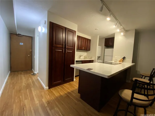 a kitchen with a sink and wooden cabinets