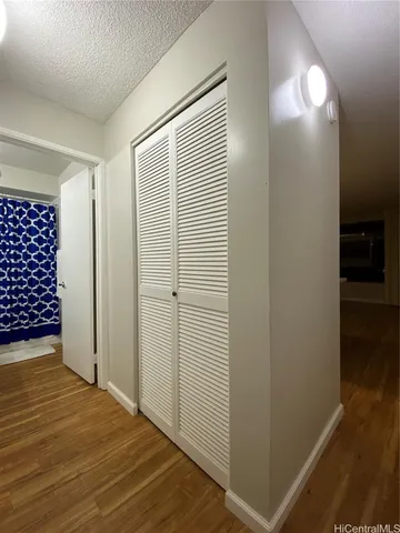an empty room with wooden floor and closet