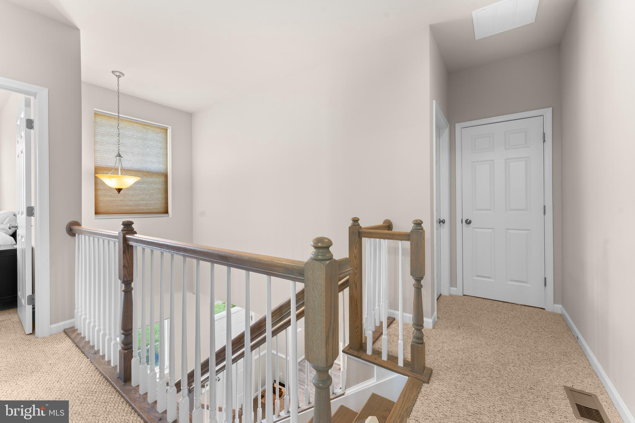 10541 Blazing Star Loop Bristow, VA 20136 - Photo 22 of 41 a view of a hallway with wooden floor and dining room