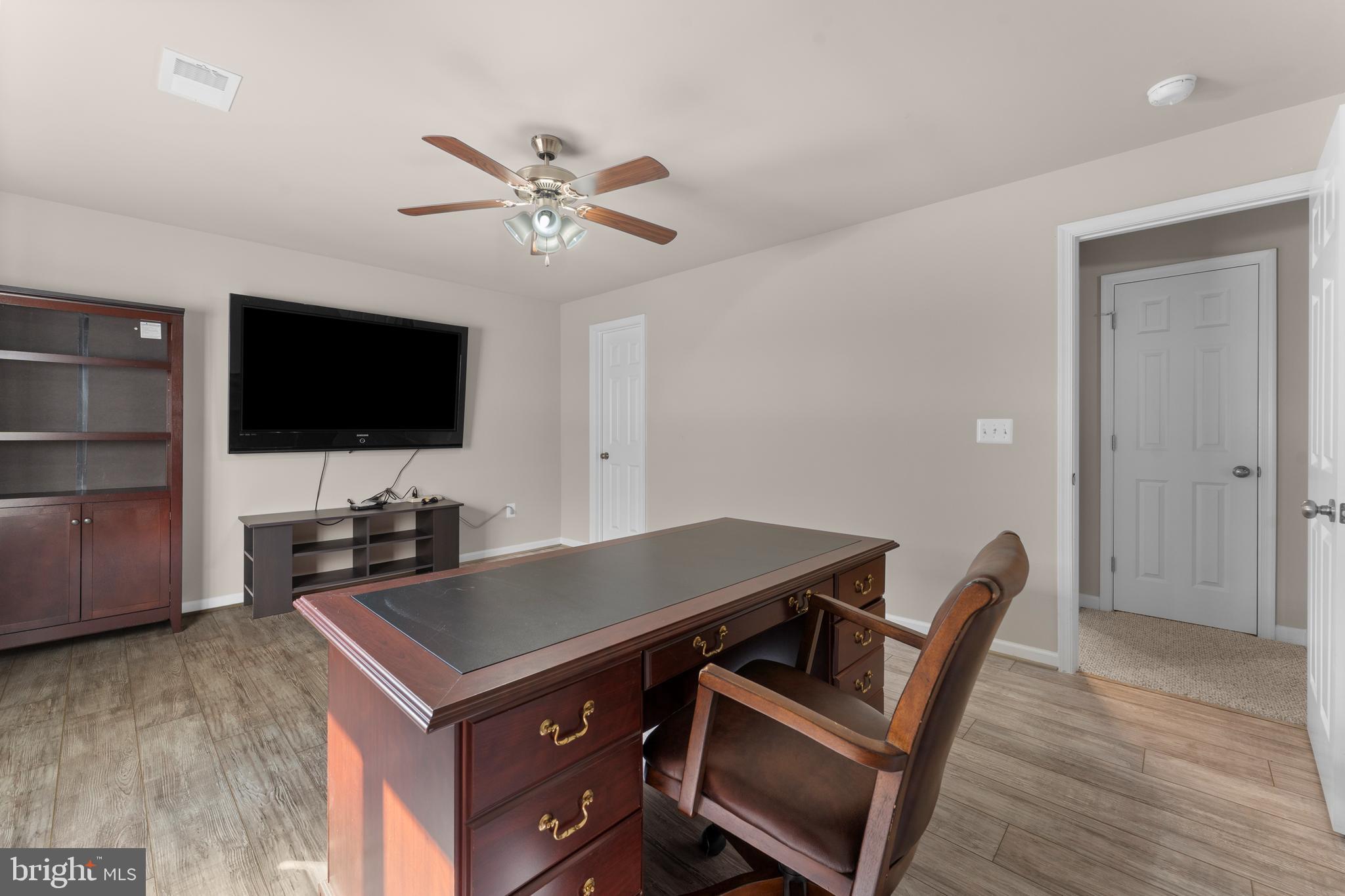 10541 Blazing Star Loop Bristow, VA 20136 - Photo 30 of 41 a living room with furniture and a flat screen tv
