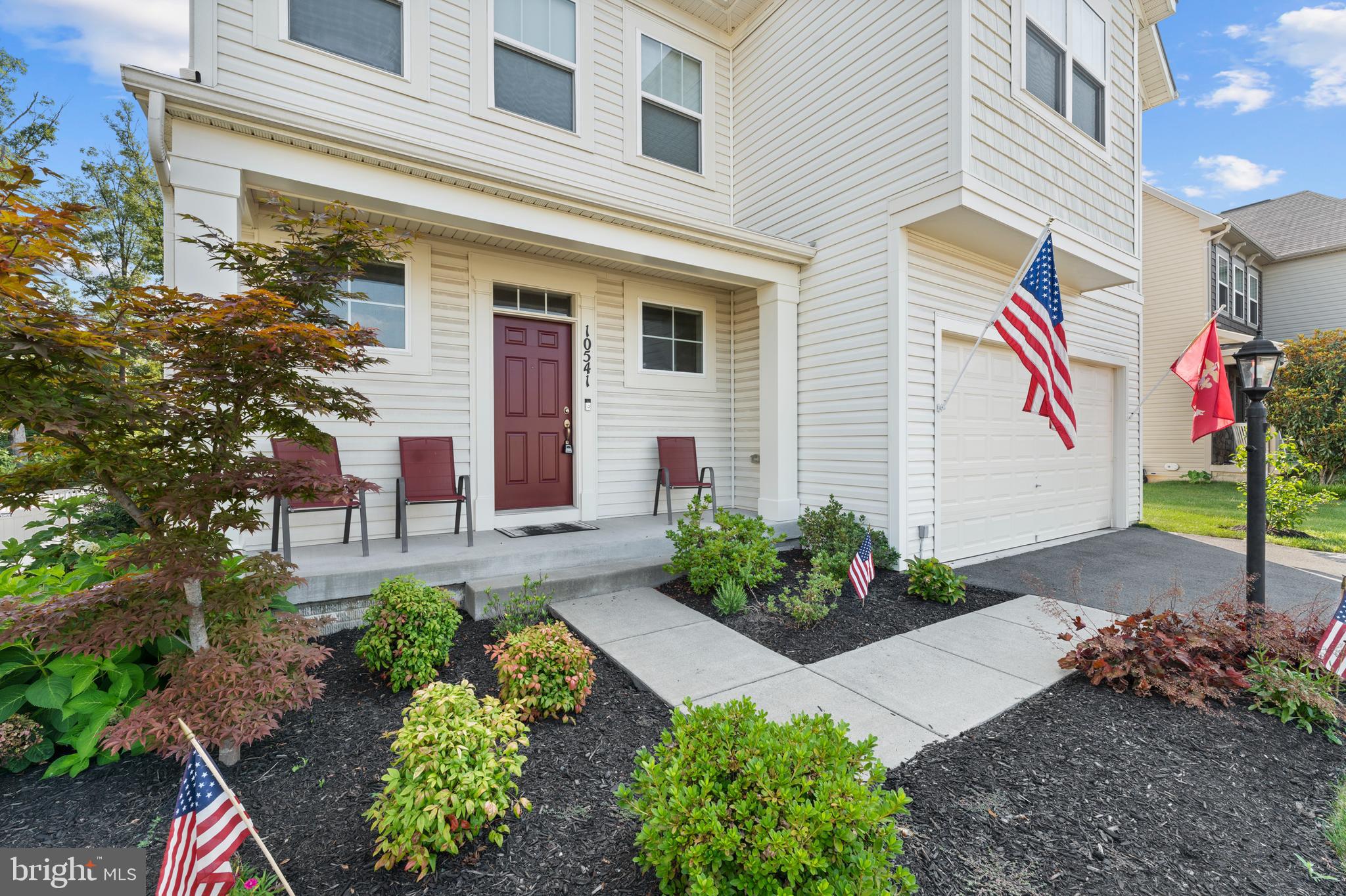10541 Blazing Star Loop Bristow, VA 20136 - Photo 4 of 41 a front view of a house with a yard and outdoor seating