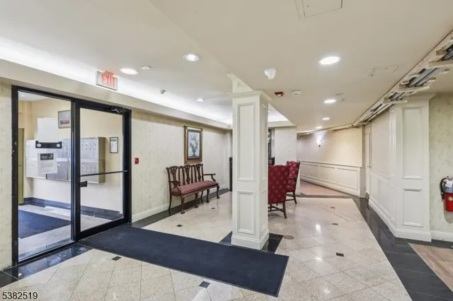a lobby with furniture and a potted plant