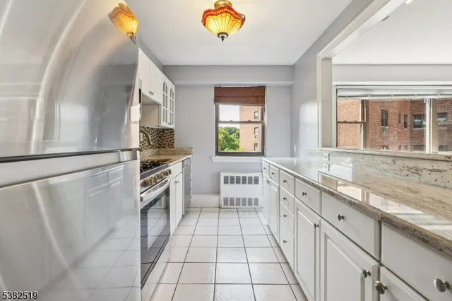 a large white kitchen with a stove a sink and a refrigerator