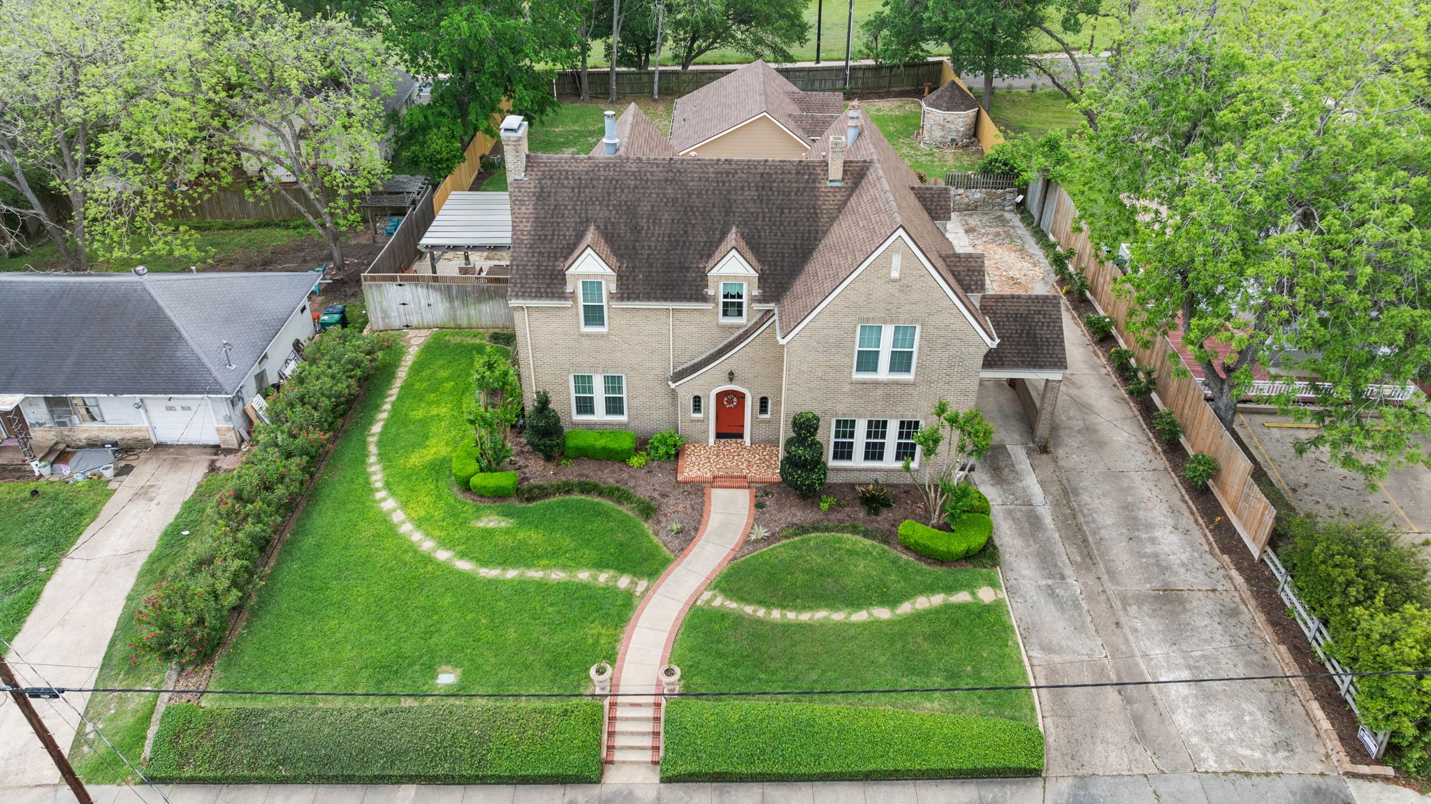 801 West Main Street Brenham, TX 77833 - Photo 2 of 50 Set on a beautifully landscaped lot, this stately brick home offers timeless curb appeal with manicured grounds, mature trees, a charming front walk, and an inviting entry. The expansive driveway and porte cochere provides abundant parking, while the home's classic architecture reflects the rich history and elegance preserved throughout.