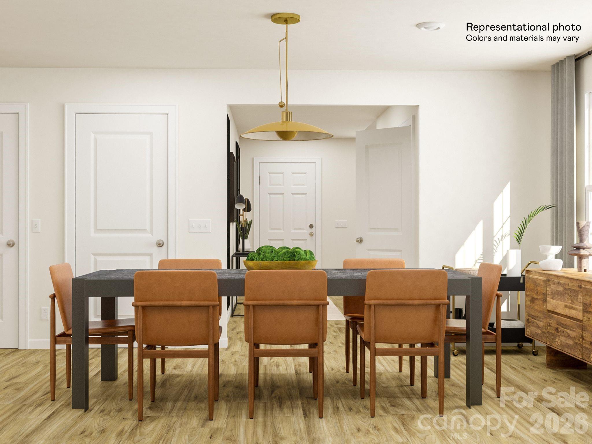 141 Spotted Way Troutman, NC 28166 - Photo 11 of 28 a dining room with furniture and wooden floor