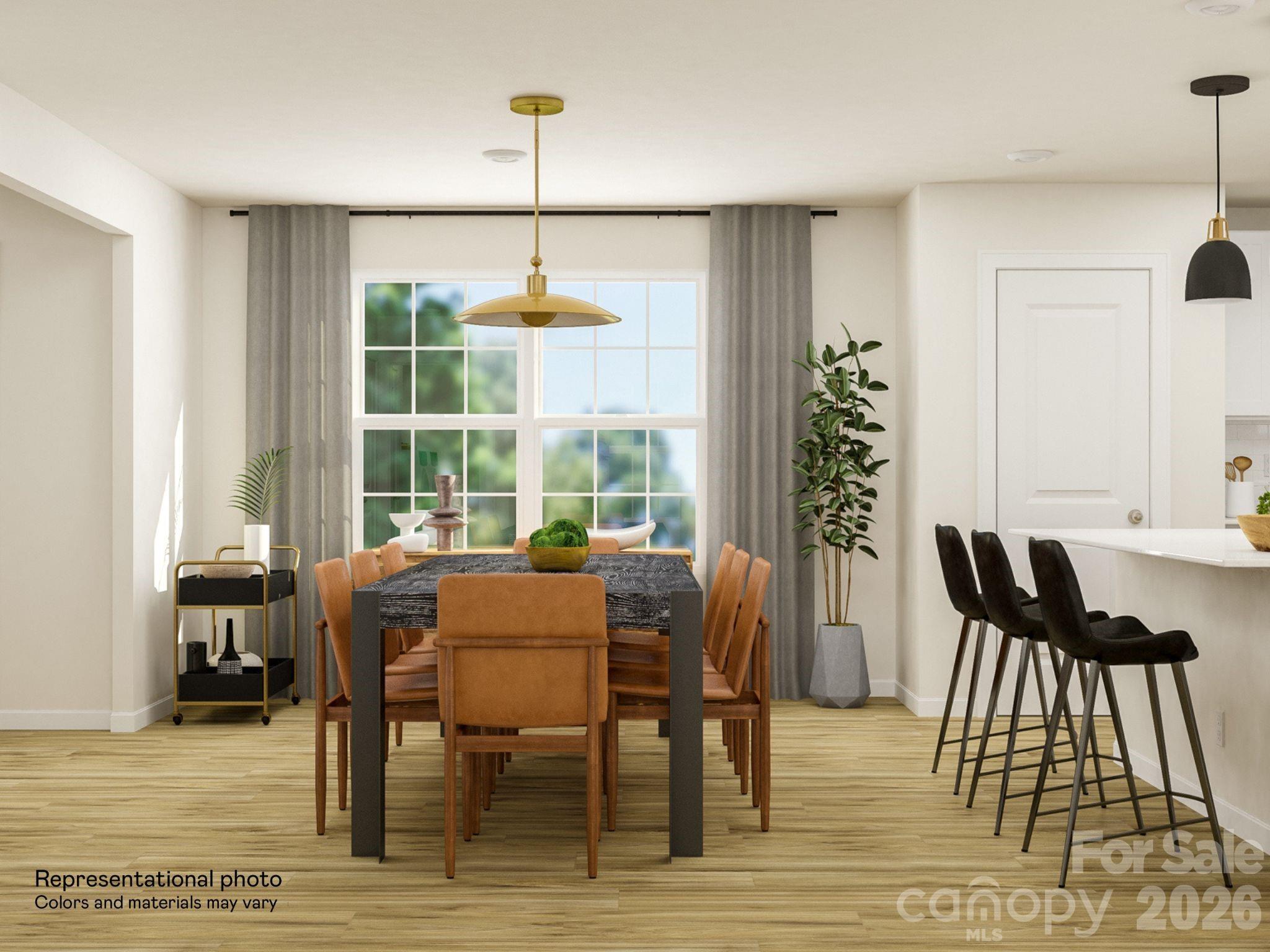 141 Spotted Way Troutman, NC 28166 - Photo 12 of 28 a view of a dining room with furniture window and wooden floor
