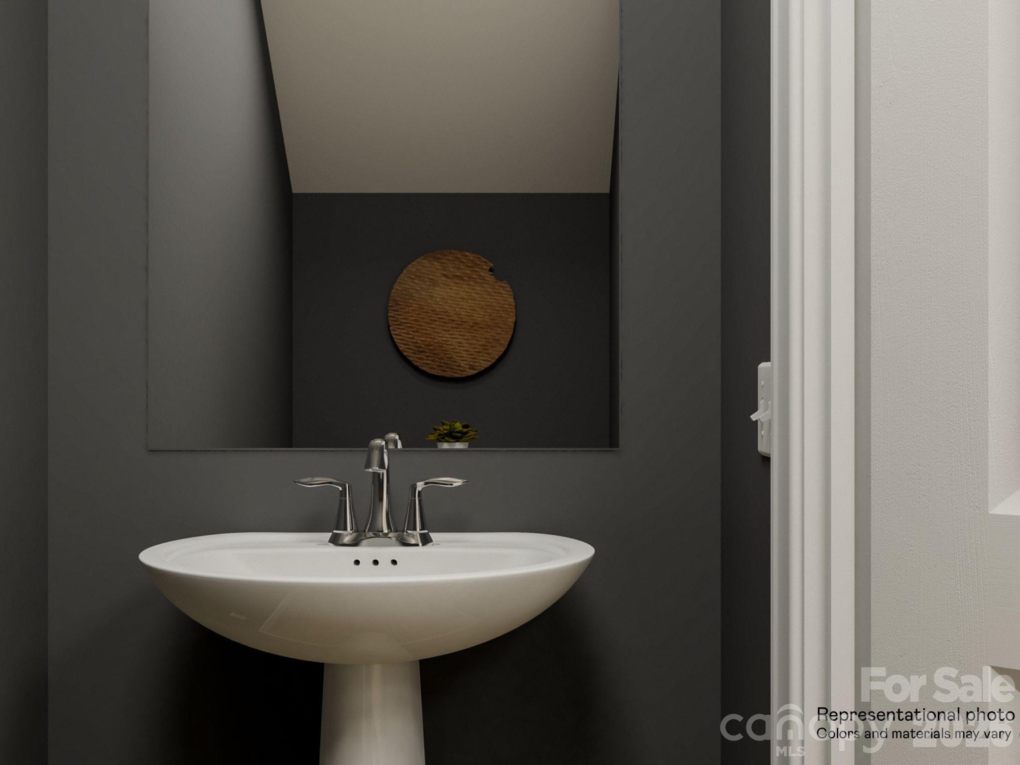 141 Spotted Way Troutman, NC 28166 - Photo 25 of 28 a bathroom with a sink and mirror