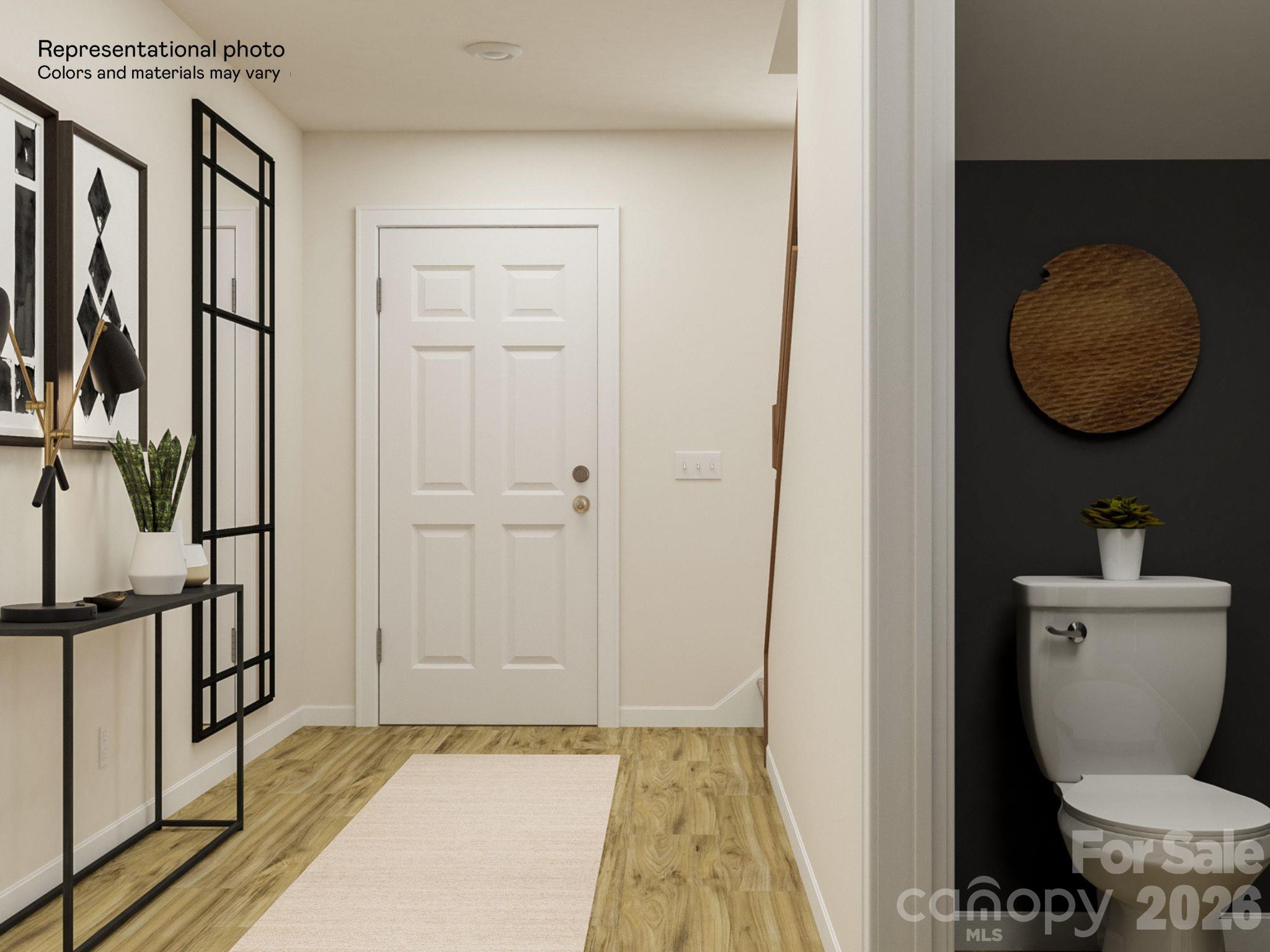 141 Spotted Way Troutman, NC 28166 - Photo 26 of 28 a bathroom with a toilet and a mirror