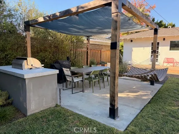 a patio with a table and chairs