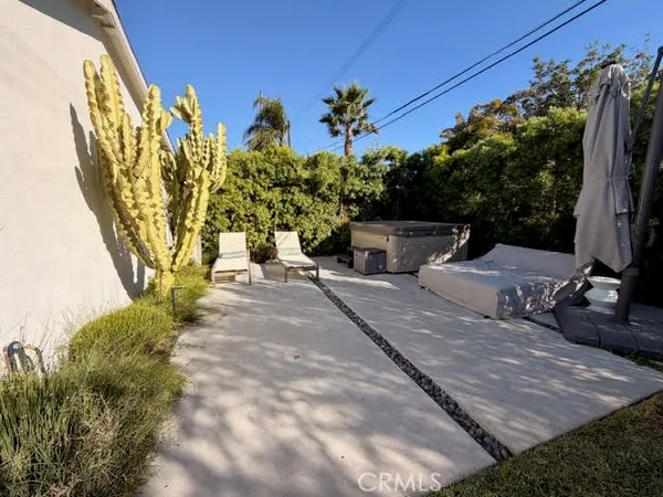 a view of a patio with table and chairs and potted plants