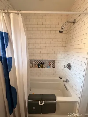 a bathroom with a tub and a shower