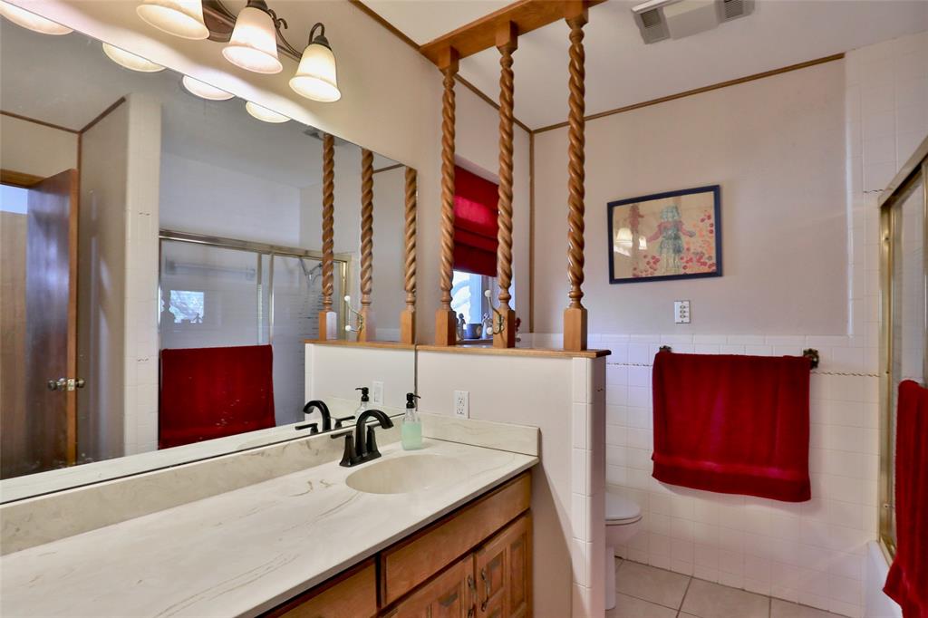 448 Elmdale Road South Abilene, TX 79602 - Photo 19 of 39 a bathroom with a sink vanity and a mirror