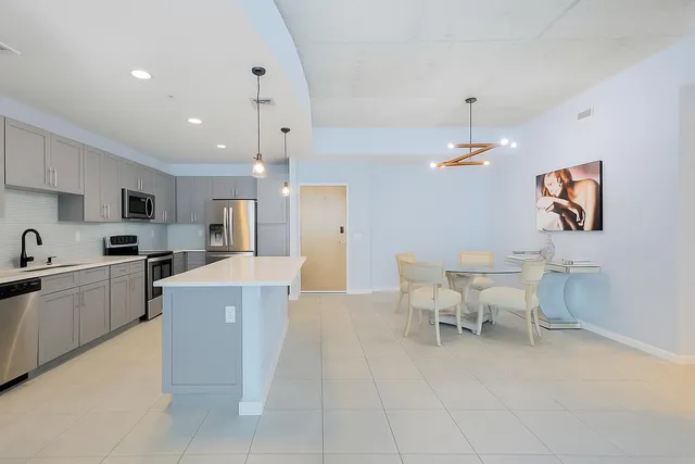 a bedroom with a large bed and a chandelier