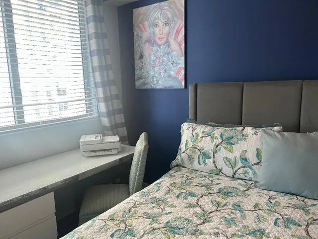 a bedroom with a bed and a window