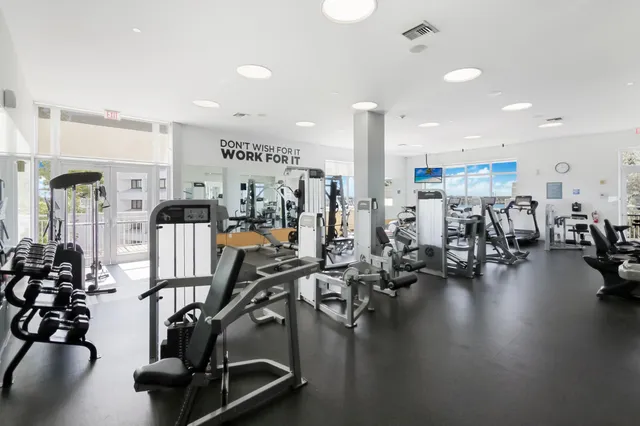 a kitchen with stainless steel appliances kitchen island granite countertop a refrigerator and a stove