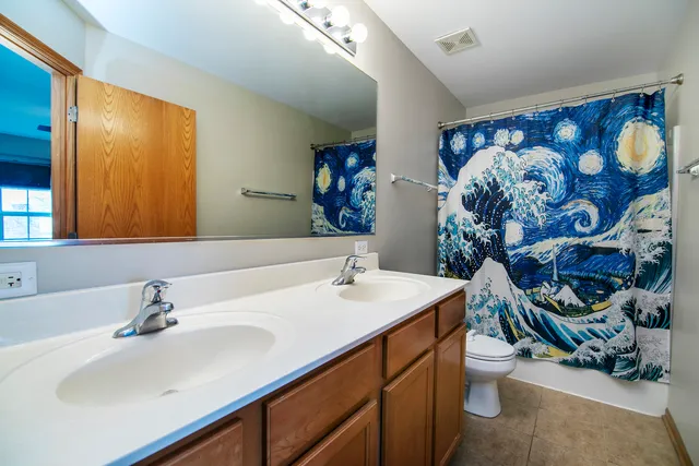a bathroom with a sink mirror and vanity