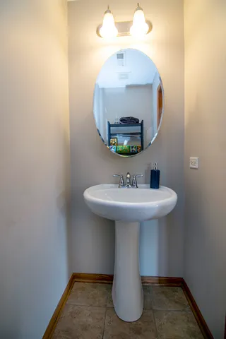 a bathroom with a sink a mirror and vanity