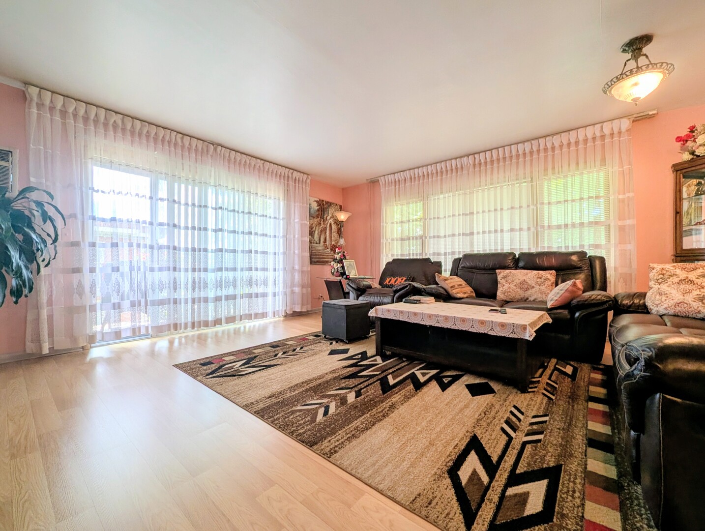 4229 North Keystone Avenue, Unit 3H Chicago, IL 60641 - Photo 4 of 22 a living room with furniture a rug and a large window